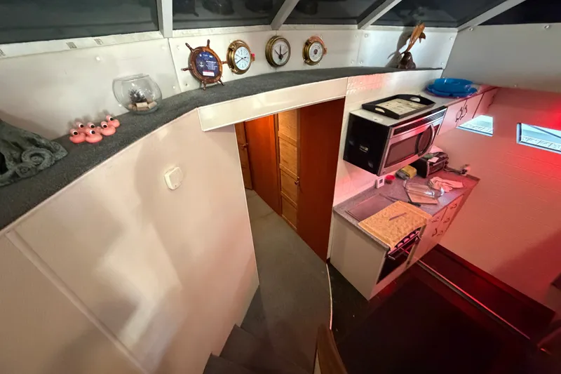 Slide: The Image of Interior of a 1996 WEIST 62 Convertible yacht with kitchen and nautical decor. - 31