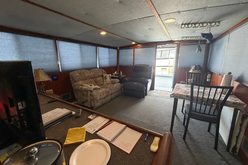 Slide: The Image of Interior of a 1996 WEIST 62 Convertible boat with cozy seating and dining area. - 29