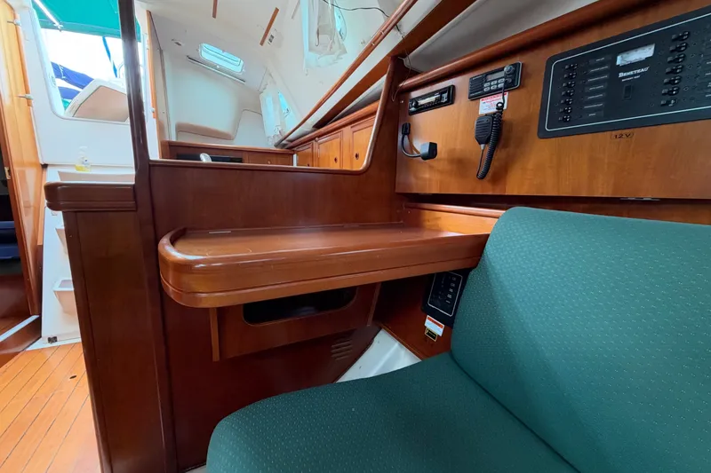 Slide: The Image of Interior of 2001 Beneteau Oceanis 331 sailboat with navigation station and green seating. - 19