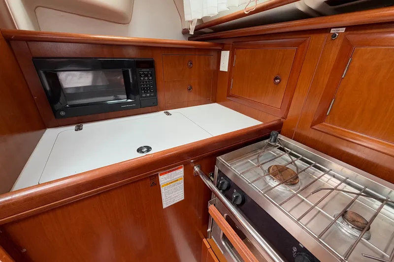 Slide: The Image of Galley kitchen in 2001 Beneteau Oceanis 331 sailboat with stove and microwave. - 17