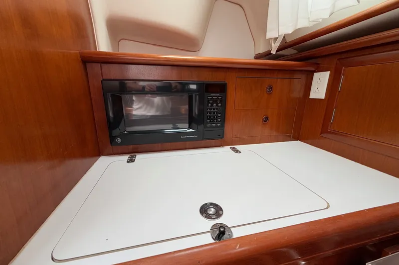 Slide: The Image of Interior of 2001 Beneteau Oceanis 331 yacht with microwave and wooden cabinetry. - 16
