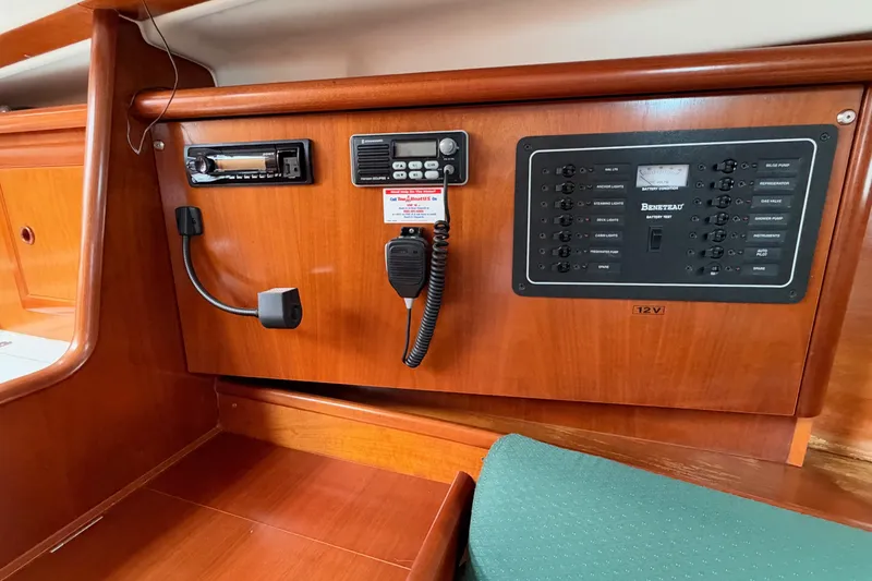 Slide: The Image of Control panel of a 2001 Beneteau Oceanis 331 sailboat, featuring radio and electrical switches. - 18