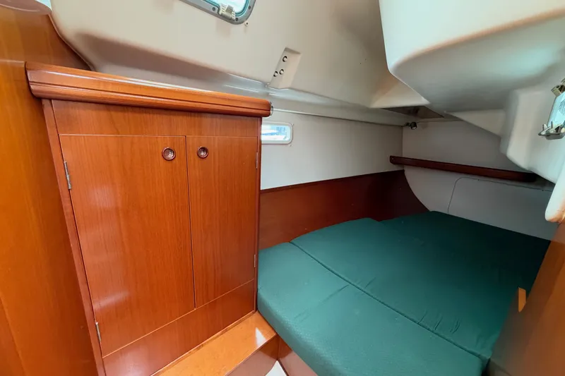 Slide: The Image of Cozy cabin interior of 2001 Beneteau Oceanis 331 sailboat with wooden cabinetry. - 22