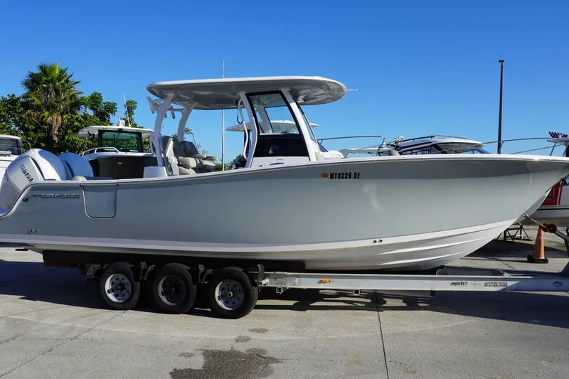 Slide: The Image of 2022 Sportsman Open 282TE Center Console boat on trailer, parked outdoors. - 1