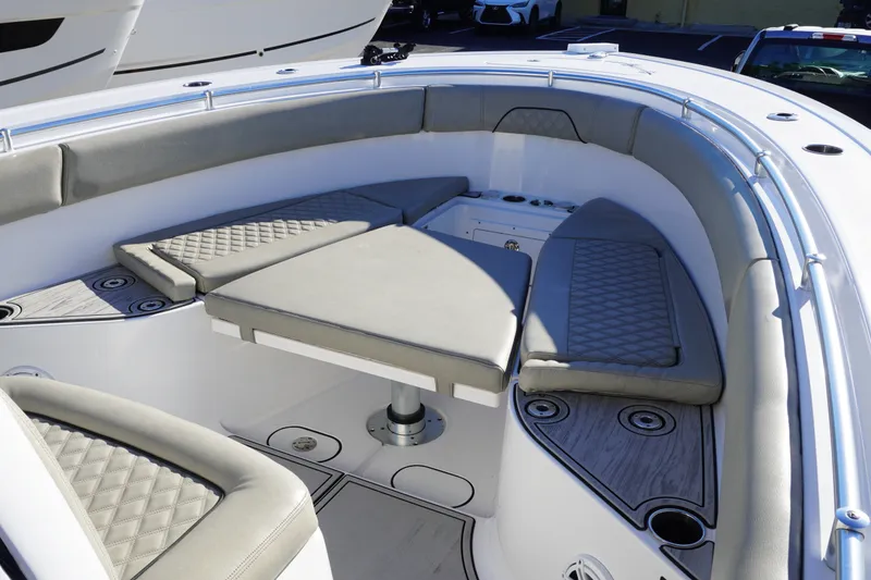 Slide: The Image of 2022 Sportsman Open 282TE Center Console boat with cushioned seating and modern design. - 19