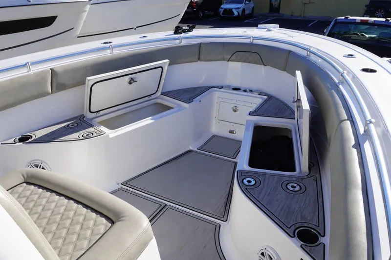 Slide: The Image of 2022 Sportsman Open 282TE Center Console boat interior with storage compartments and seating. - 16
