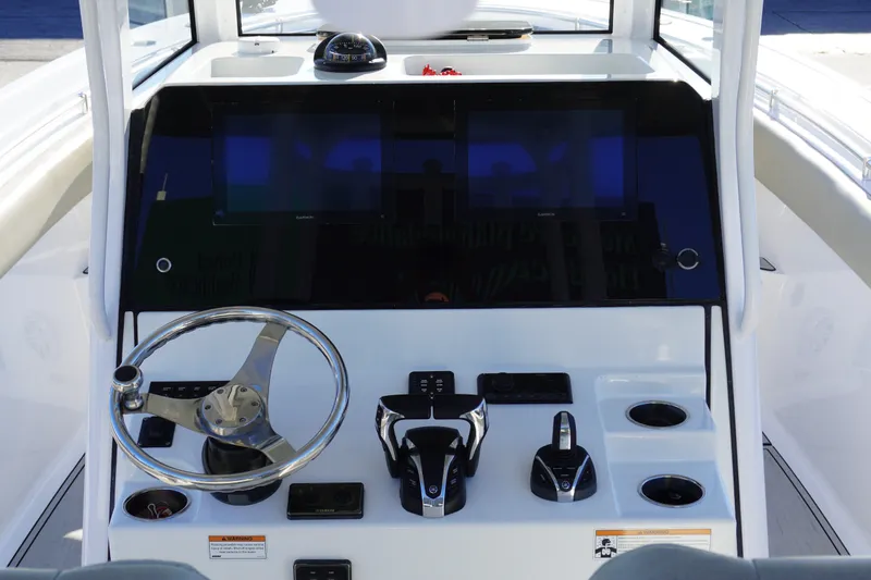 Slide: The Image of Center console of 2022 Sportsman Open 282TE boat with steering wheel and controls. - 11
