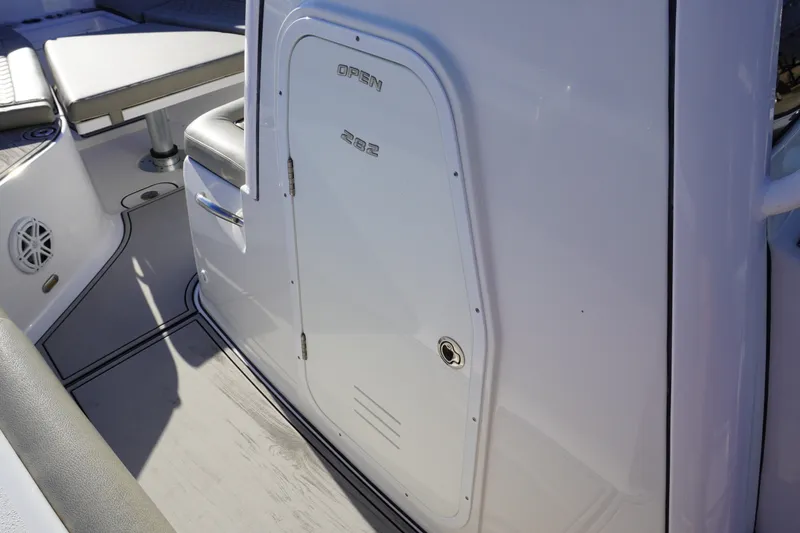 Slide: The Image of 2022 Sportsman Open 282TE Center Console boat interior with seating and storage. - 23