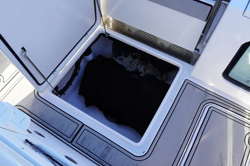 Slide: The Image of Open storage compartment on 2022 Sportsman Open 282TE Center Console boat. - 5
