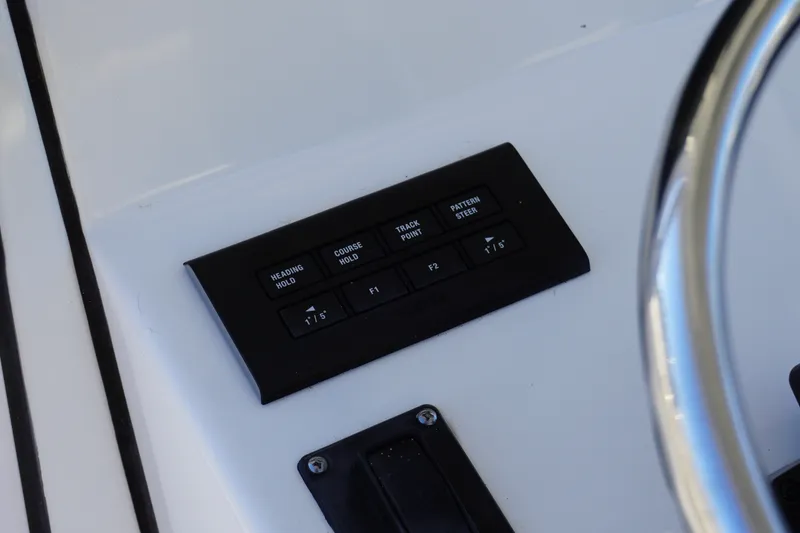 Slide: The Image of Control panel of 2022 Sportsman Open 282TE Center Console boat, featuring navigation buttons. - 13