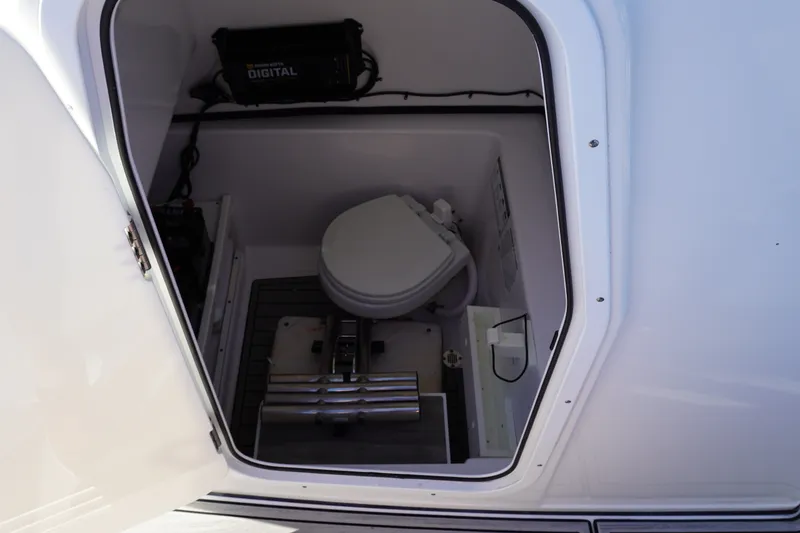 Slide: The Image of 2022 Sportsman Open 282TE Center Console boat interior with marine toilet. - 24