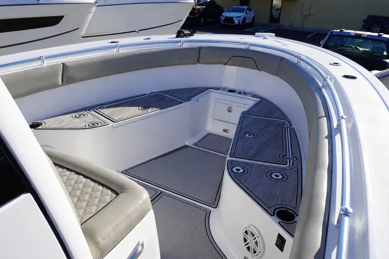 Slide: The Image of 2022 Sportsman Open 282TE Center Console boat interior with cushioned seating and storage compartments. - 15