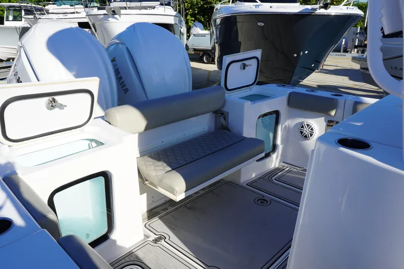 Slide: The Image of 2022 Sportsman Open 282TE Center Console boat interior with seating and storage compartments. - 4