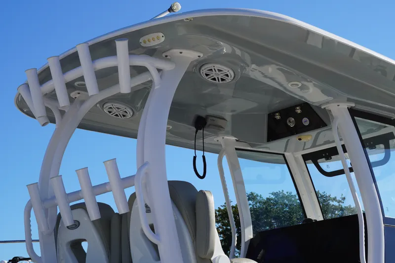 Slide: The Image of 2022 Sportsman Open 282TE Center Console boat with rod holders and speakers. - 8