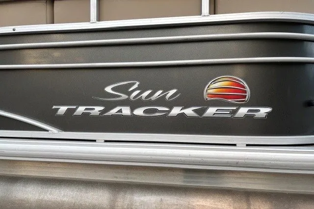 Slide: The Image of 2021 Sun Tracker Party Barge 24 DLX logo on boat exterior, featuring sleek design. - 19