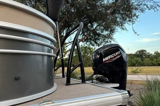 Slide: The Image of 2021 Sun Tracker Party Barge 24 DLX with Mercury outboard motor, docked outdoors. - 12