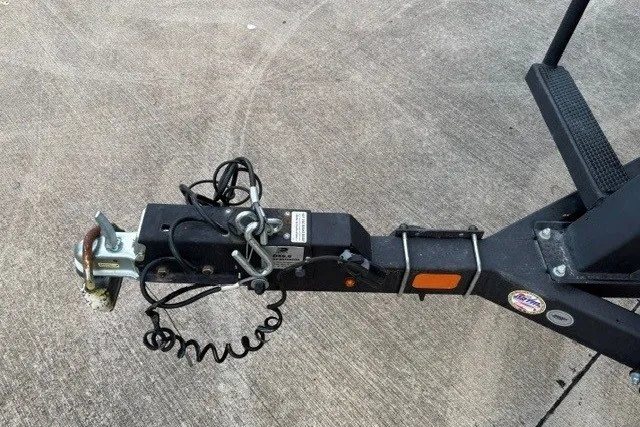 Slide: The Image of Trailer hitch of a 2021 Sun Tracker Party Barge 24 DLX on concrete surface. - 15