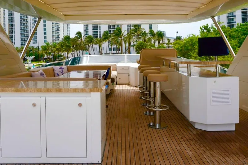 Slide: The Image of Luxurious 2015 Azimut 84 yacht deck with bar, seating, and scenic view. - 20