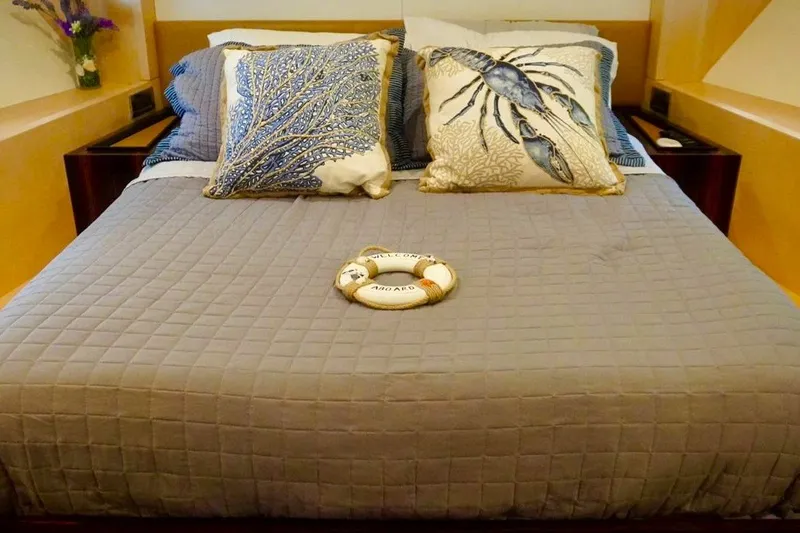 Slide: The Image of Luxurious Azimut 84 yacht bedroom with nautical-themed pillows and decor, 2015 model. - 15