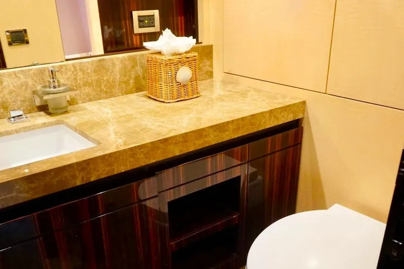 Slide: The Image of Luxurious bathroom interior on 2015 Azimut 84 yacht with marble countertop and wicker basket. - 16
