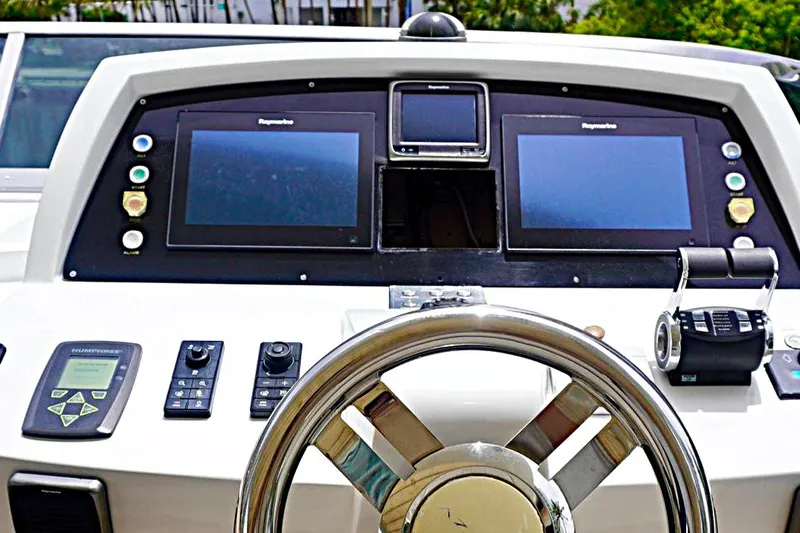 Slide: The Image of Control panel of a 2015 Azimut 84 yacht with navigation screens and steering wheel. - 22