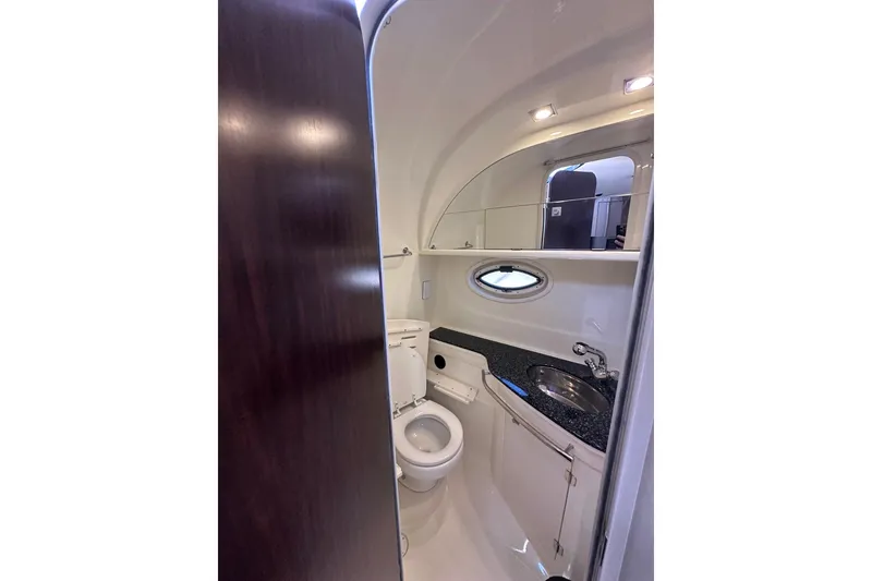 Slide: The Image of Bathroom interior of 2012 Monterey 340 Sport Yacht with sink, toilet, and mirror. - 15