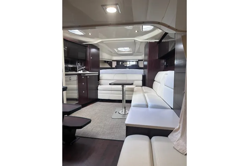Slide: The Image of Luxurious interior of a 2012 Monterey 340 Sport Yacht with white seating and modern amenities. - 18