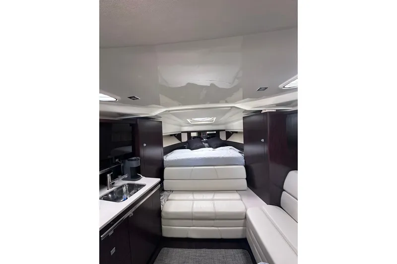 Slide: The Image of Interior of 2012 Monterey 340 Sport Yacht with modern furnishings and compact kitchen area. - 21