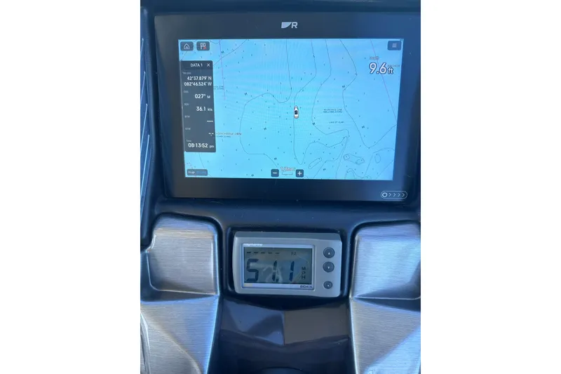 Slide: The Image of Dashboard of a 2012 Monterey 340 Sport Yacht displaying navigation and speed data. - 17