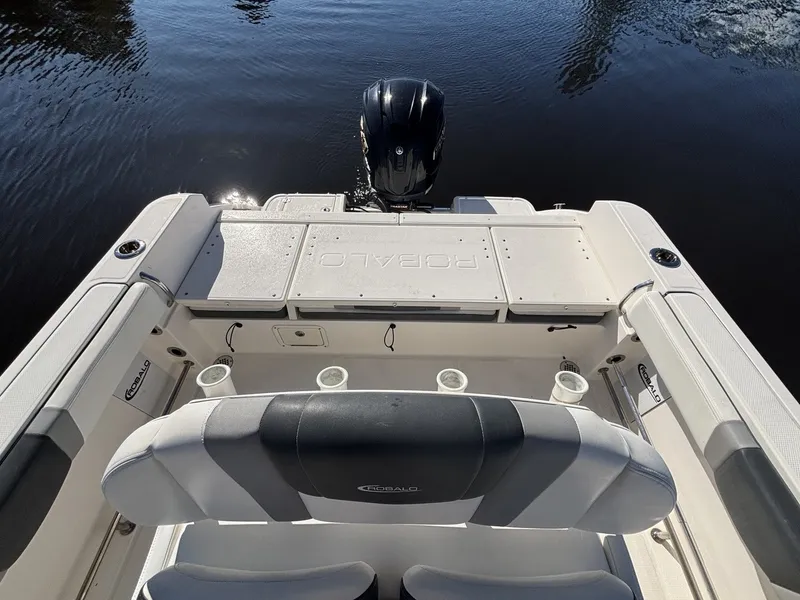 Slide: The Image of The image shows the stern of a 2021 Robalo R230 Center Console boat with an outboard motor. - 12
