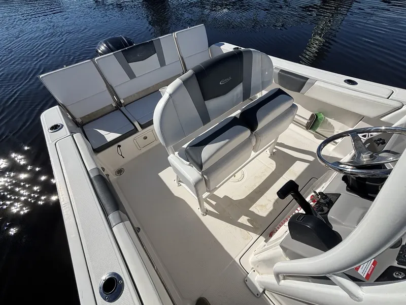 Slide: The Image of The image shows the cockpit of a 2021 Robalo R230 Center Console boat with gray seating. - 10