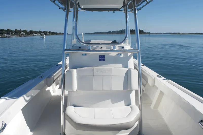 Slide: The Image of 2023 Parker 2300 Special Edition boat on calm water, showcasing sleek design and seating. - 11