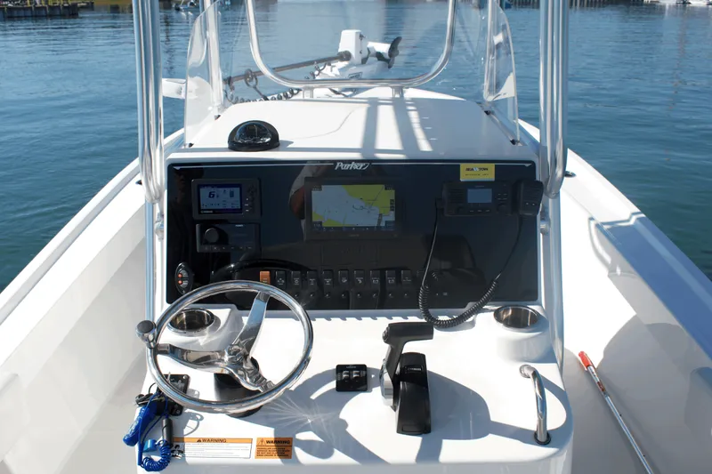 Slide: The Image of 2023 Parker 2300 Special Edition boat console with navigation equipment and steering wheel. - 12