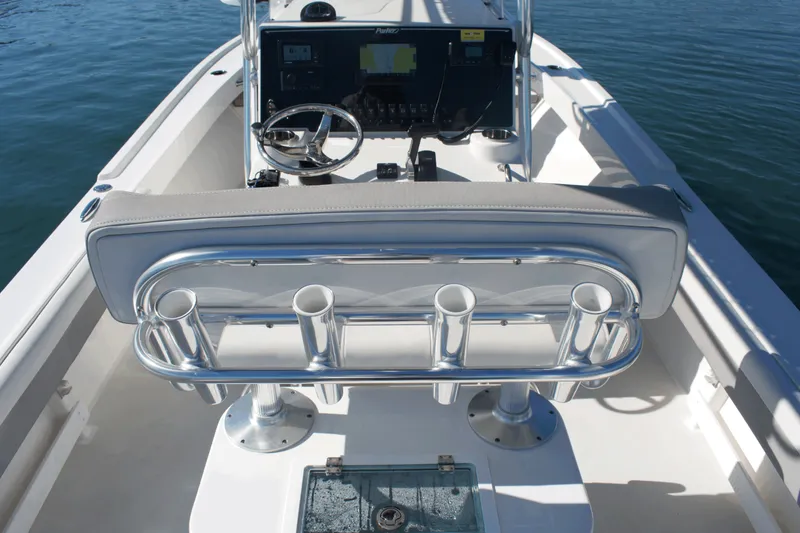 Slide: The Image of 2023 Parker 2300 Special Edition boat interior with steering wheel and rod holders. - 18