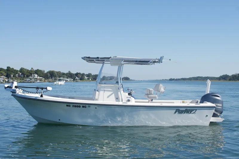 Slide: The Image of 2023 Parker 2300 Special Edition boat on calm water, featuring sleek design and Yamaha engine. - 2