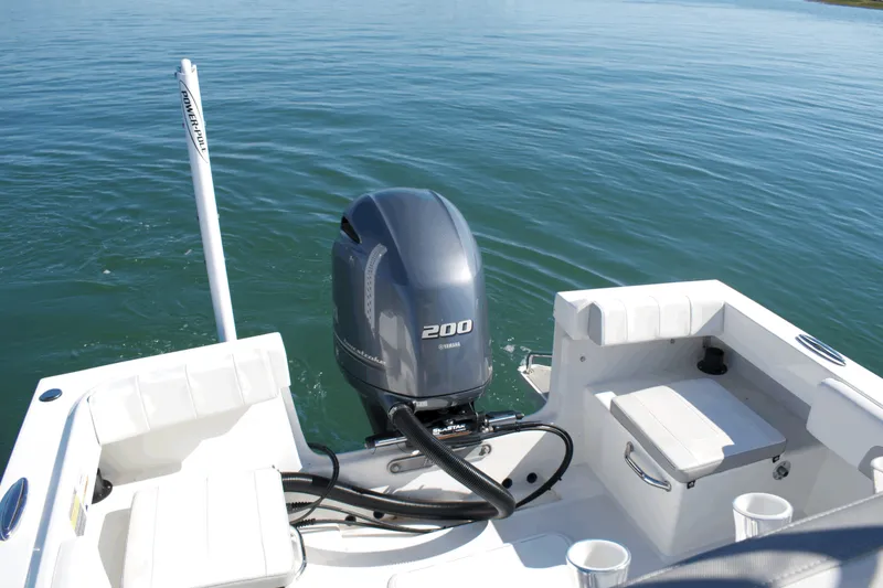 Slide: The Image of 2023 Parker 2300 Special Edition boat with Yamaha 200 outboard motor on calm water. - 23