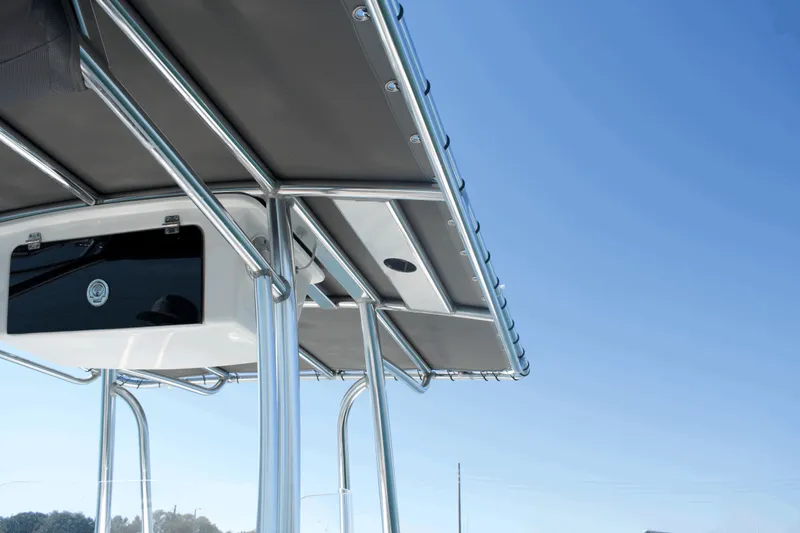 Slide: The Image of 2023 Parker 2300 Special Edition boat with sleek metal framework and canopy against clear blue sky. - 20