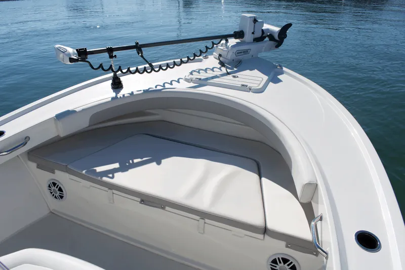 Slide: The Image of 2023 Parker 2300 Special Edition boat with cushioned seating and trolling motor on calm water. - 9