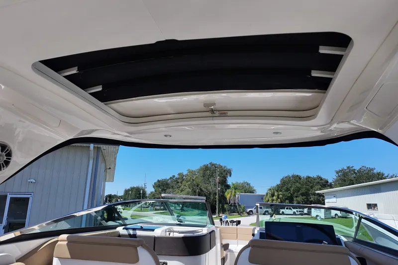 Slide: The Image of 2024 Sea Ray SLX 310 boat interior with open sunroof and seating area. - 15