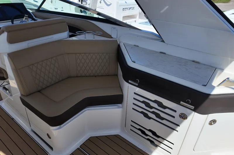 Slide: The Image of Luxurious seating area on 2024 Sea Ray SLX 310 boat with elegant design and storage. - 13
