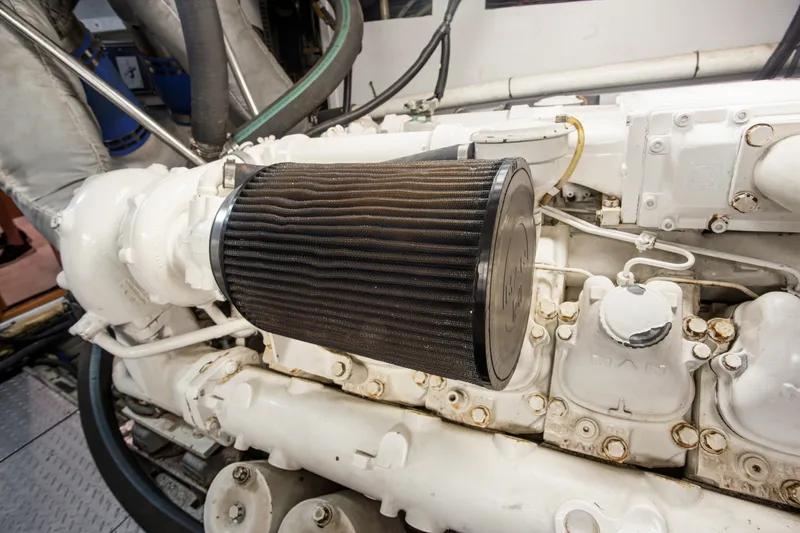Slide: The Image of Engine compartment of a 1993 Johnson 56 Motor Yacht, featuring a prominent air filter. - 45