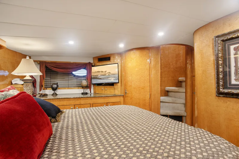 Slide: The Image of Luxurious interior of 1993 Johnson 56 Motor Yacht with elegant wood finishes and cozy decor. - 14