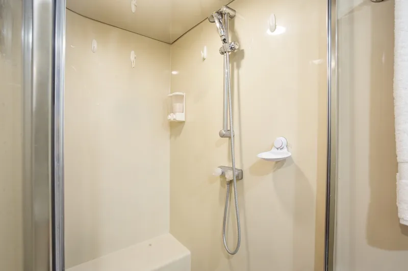 Slide: The Image of Shower area in 1993 Johnson 56 Motor Yacht, featuring modern fixtures and beige walls. - 18