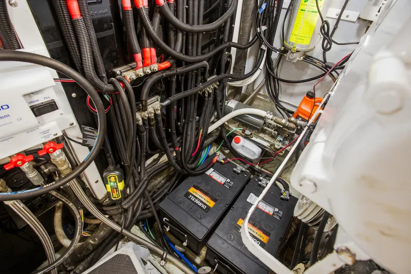 Slide: The Image of Engine room of a 1993 Johnson 56 Motor Yacht with batteries and wiring. - 41