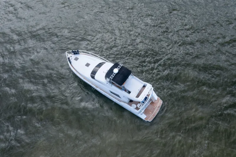 Slide: The Image of Aerial view of a 1993 Johnson 56 Motor Yacht cruising on open water. - 49