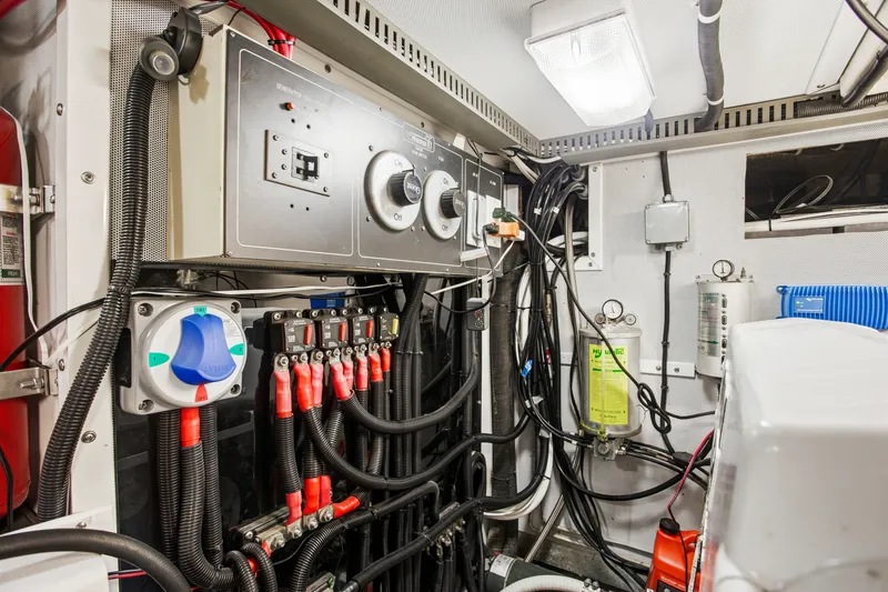 Slide: The Image of Engine room of a 1993 Johnson 56 Motor Yacht, showcasing electrical panels and wiring. - 39