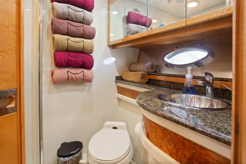 Slide: The Image of Luxurious bathroom in 1993 Johnson 56 Motor Yacht with granite countertop and stacked towels. - 22