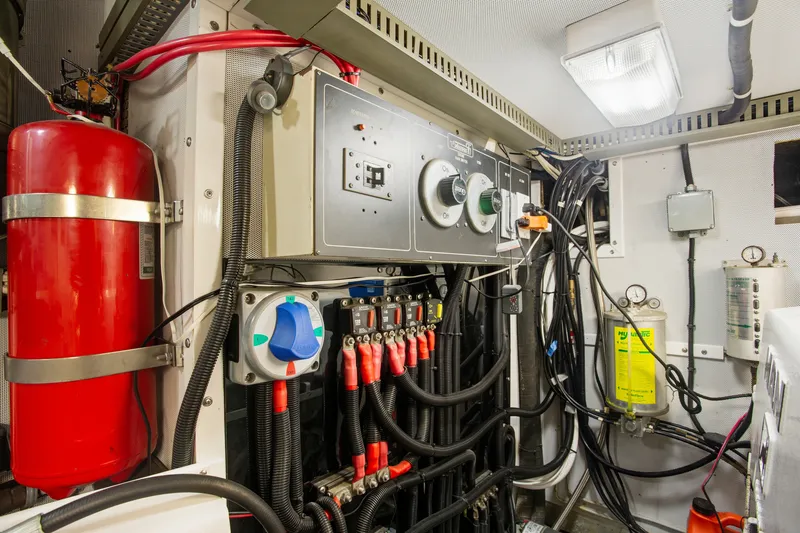 Slide: The Image of Engine room of a 1993 Johnson 56 Motor Yacht with control panels and safety equipment. - 43