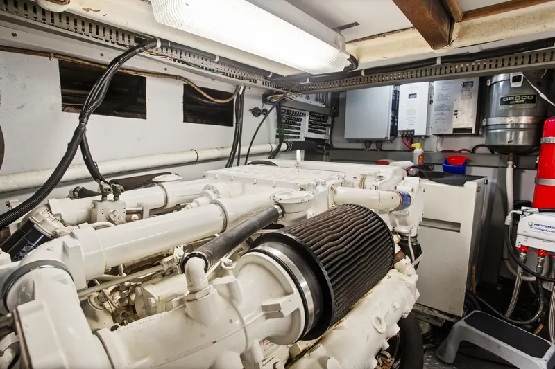 Slide: The Image of Engine room of a 1993 Johnson 56 Motor Yacht, showcasing machinery and equipment. - 37