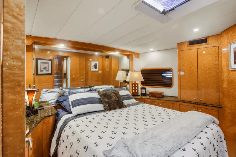 Slide: The Image of Luxurious bedroom interior of 1993 Johnson 56 Motor Yacht with elegant wood finishes. - 20